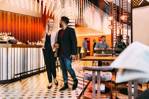 A modern restaurant bar interior with contemporary design elements and lighting fixtures.