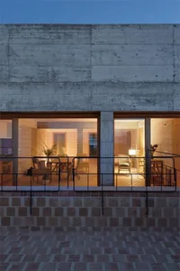 Concrete interior of a living room with warm lighting