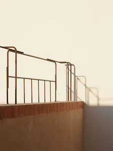 A modern balcony with a metal railing.