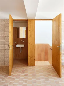 Modern bathroom featuring ceramic tile flooring and walls with a minimalist design.