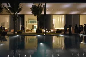 A modern residential living space featuring concrete and glass materials.