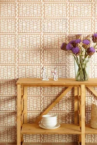 A modern interior decor scene featuring a wooden side table with decorative items and a floral arrangement.
