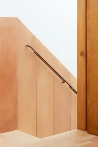 Modern interior wall adorned with a steel handrail.