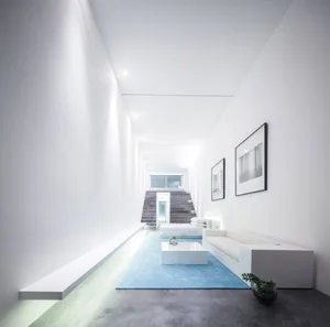 A minimalist interior design featuring modern furniture and concrete elements.