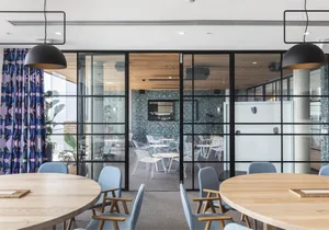 Modernly designed office conference room featuring glass and steel materials.
