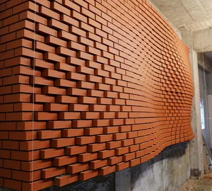 A section of a constructed brick wall in a building under development.