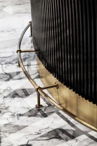 Modern black furniture with metallic accents on a marble flooring.
