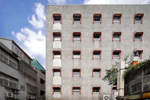 A modern apartment building constructed with concrete materials.