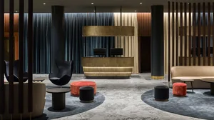 A modern interior space featuring metal, wood, carpet, and marble materials.