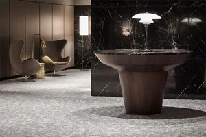 A modern interior design featuring a wooden table with a marble top and a marble wall.