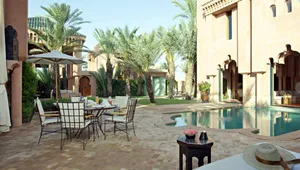 A modern lounge area with stone-paved flooring and ceramic-tiled walls.