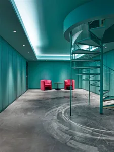 Modern office lounge featuring metal and concrete materials.