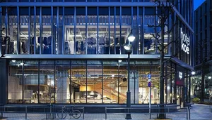 A modern retail storefront with glass, brick, and concrete materials