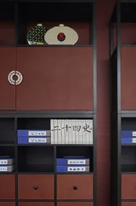 A modern metal bookshelf with books and decorative items on display.