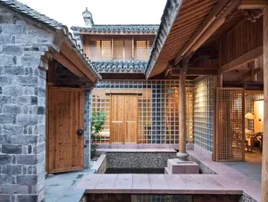 A traditional Chinese interior with wooden walls and a stone step leading to a lower floor.