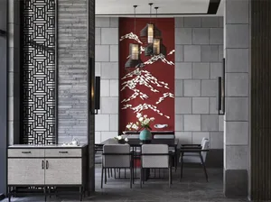 A modern dining room featuring a concrete wall, fabric upholstered chairs, and a large red artwork with white birds and lante