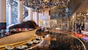 An image of a modern hotel lobby with metallic acrylic panels on the walls.