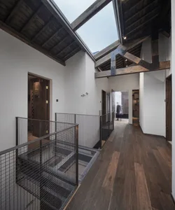 Industrial-style architecture with wooden materials and open ceiling beams.