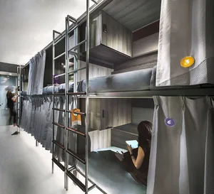A metal bunk bed system with industrial design featuring wooden bunk beds and grey fabric curtains.