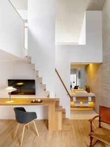 A minimalist office workspace featuring wood and concrete materials.