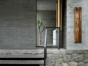 Concrete and stone entrance with minimalist design elements.