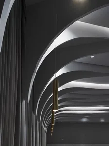 A modern interior space with curved, metallic lighting fixtures.
