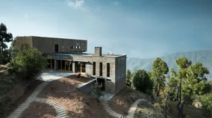 Modern residential architecture featuring stone and glass materials.