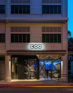 Modern storefront entrance with concrete texture and colorful patterns