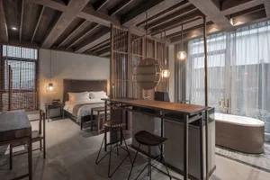 A minimalist bedroom suite featuring wooden furniture and decor.