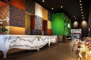 Hotel reception lobby area with decorative textiles on walls and furniture, designed to welcome guests.