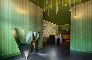 A modern restaurant lobby with metallic green features