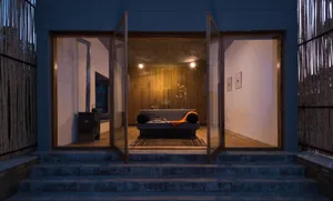 A modern bedroom interior with warm lighting and wooden elements.
