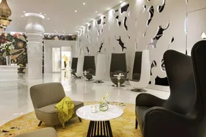 Modern, minimalist lounge area with concrete, marble, and metal accents.