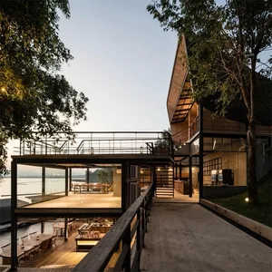 A modern architectural structure featuring glass, concrete, and wooden elements.