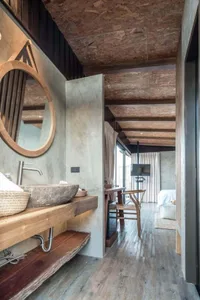 Modern bathroom design featuring concrete countertop and wooden timber elements