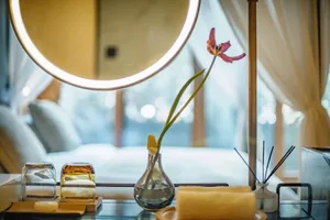 A modern bedroom with glass elements and decorative items.