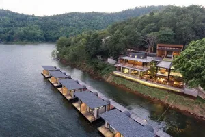 Floating Resort with Modern Architectural Design, Concrete Roofs, and Wooden Structure on Waterfront Location