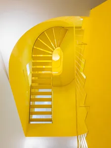 A bright yellow spiral staircase