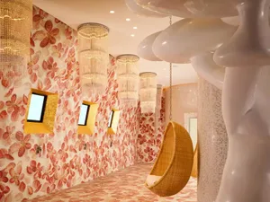 A modern hotel suite with glass walls and a spacious interior.