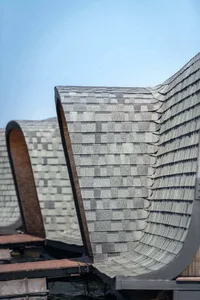 A close-up view of a floating roof with composite roof tiles on a clear day.