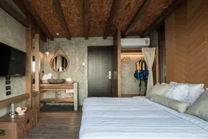 Modern industrial hotel room with concrete walls and wooden accents