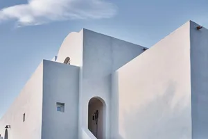 A modern, minimalist building with clean lines and white rendered walls.