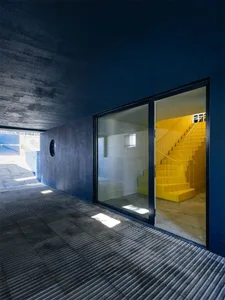 A modern interior design featuring concrete walls and floor.