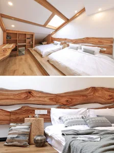 Modern minimalist bedroom with white bedding, wooden headboard, and a built-in shelf.