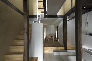 Modern minimalist house featuring wooden stairs and open space interior.