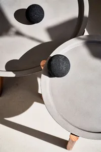 Minimalist modern side tables featuring concrete tops in a contemporary setting.