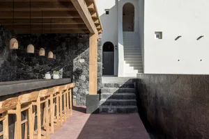 Modern staircase with terracotta tiles and concrete walls.