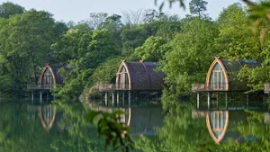 Three waterfront cabins constructed with wood, concrete, and glass.