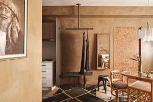 Industrial-style apartment interior featuring metal hangers and furniture.
