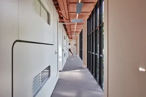 A modern office space featuring a steel wall panel and large windows.